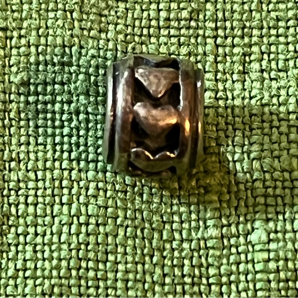Pandora silver charm with hearts carved around the barrel, 1/4” diameter